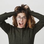 mad crazy woman tousle hair shouting anger wear crooked glasses 1 1