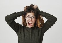mad crazy woman tousle hair shouting anger wear crooked glasses 1 1