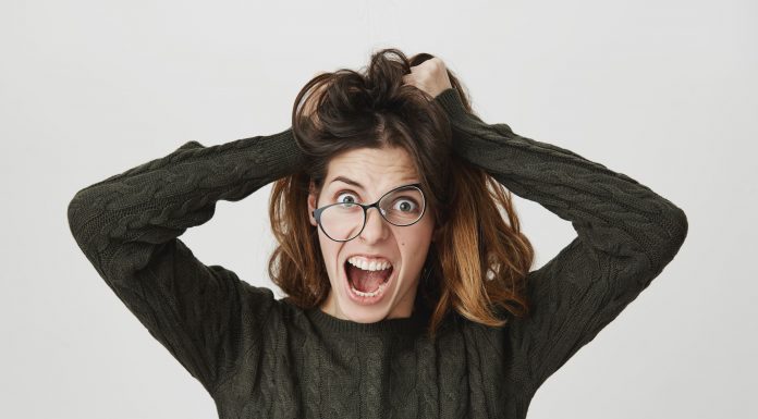 mad crazy woman tousle hair shouting anger wear crooked glasses 1 1