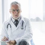 elderly therapist making notes 1 scaled