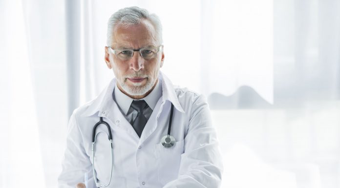elderly therapist making notes 1 scaled
