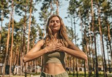 cute blonde woman practising yoga outside looking relaxed 1 1